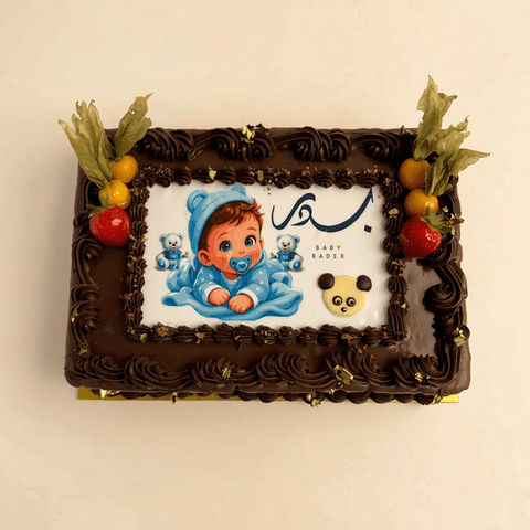 Rectangle chocolate cake decorated with gold leaf, strawberries and a printed photo